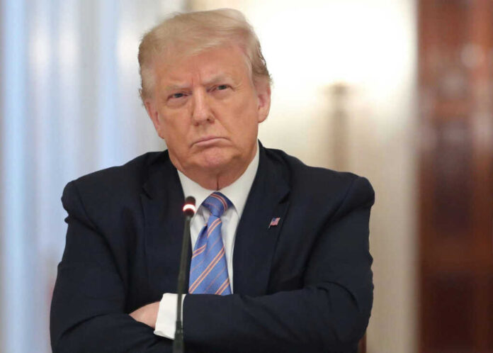 2566520813 A serious-looking individual in business attire with crossed arms in a meeting setting