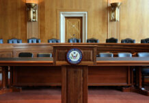 Interior view of a Senate chamber with a wooden podium and seating